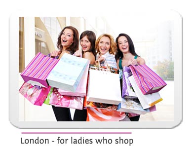 4 happy ladies with shopping bags